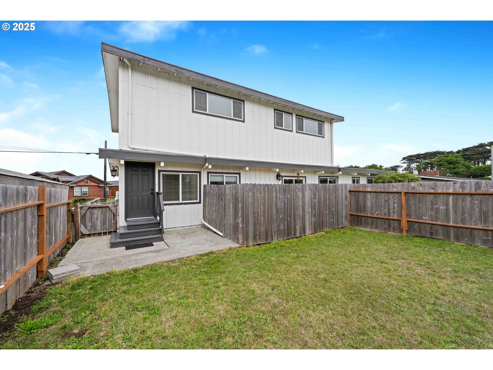 875 Ocean Drive Southwest Bandon, OR 97411 - Photo 27 of 31 a view of a backyard with a small cabin