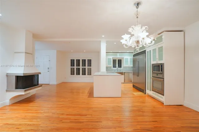 a view of a kitchen with furniture and wooden floor