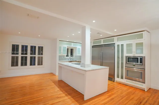 a bathroom with a sink double vanity and a large mirror