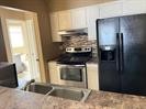 6702 Everhart Road, Unit D106 Corpus Christi, TX 78413 - Photo 2 of 4 a kitchen with a refrigerator and a stove