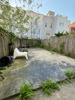a view of a house with a yard and sitting area