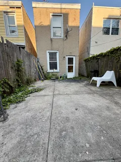 a backyard of a house with yard and outdoor seating