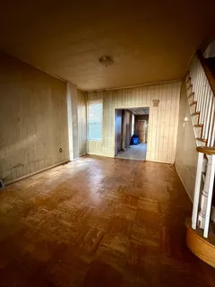 an empty room with windows and fireplace
