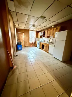 a view of a refrigerator with wooden floor