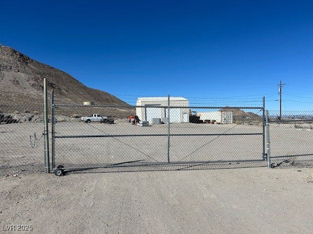 1159 South Main Street Tonopah, NV 89049 - Photo 3 of 11 View of dirt / gravel road featuring a gated entry and a mountain view