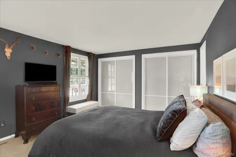 a bedroom with a bed and a flat screen tv