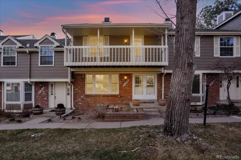 a front view of a house with garden and patio