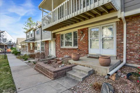 a view of a patio with couches table and chairs and potted plants