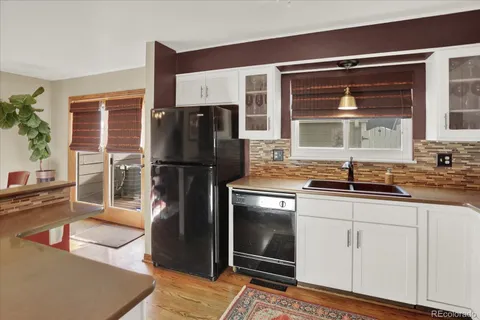 a kitchen with stainless steel appliances granite countertop a refrigerator and a sink
