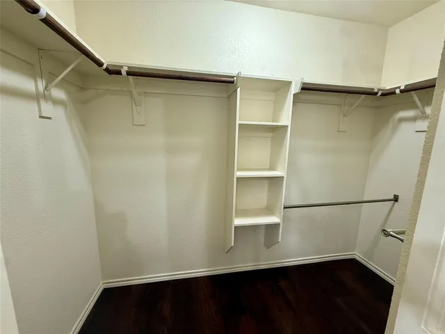 a view of walk in closet with empty racks