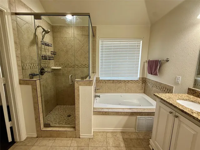 a bathroom with a granite countertop sink a toilet and shower