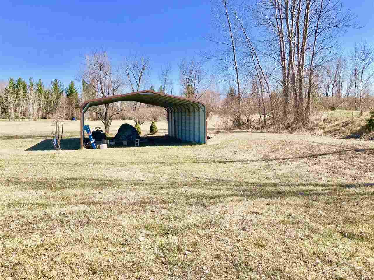 East Freeland Road Midland, MI 48640 - Photo 10 of 12 Two sided shed with covering for storage