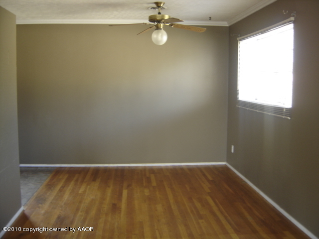 5012 South Bonham Street Amarillo, TX 79110 - Photo 2 of 5 a view of a room with wooden floor and fan