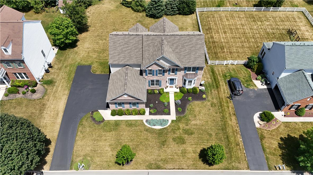 1709 Travers Road Breinigsville, PA 18031 - Photo 53 of 55 An aerial perspective showcases the inviting front exterior, complete with a well-maintained driveway and verdant landscaping.