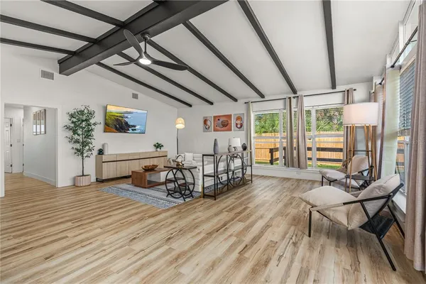 a living room with furniture and wooden floor