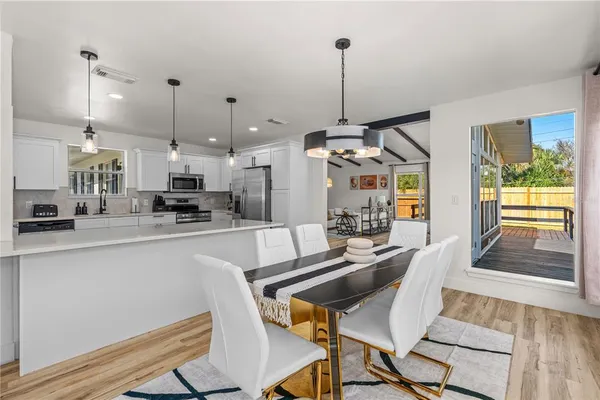 a large kitchen with kitchen island a stove a sink and a refrigerator