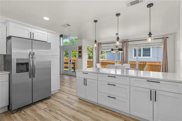 a bedroom with a large bed and a chandelier