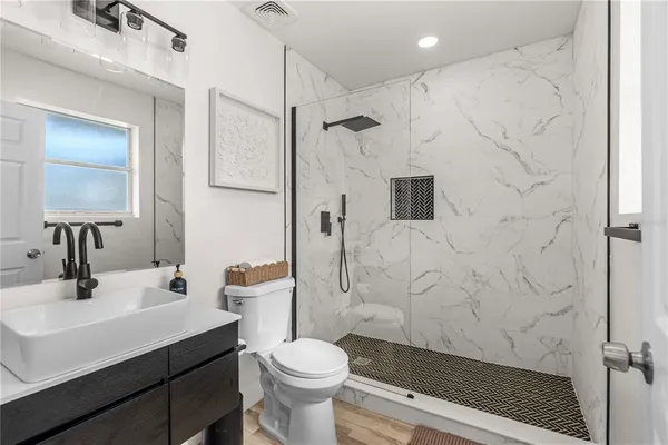 a bedroom with a bed and a large window