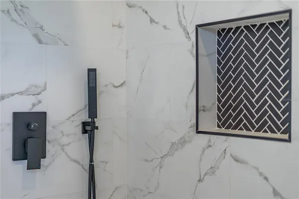 a bedroom with a bed and a flat tv screen on the dresser