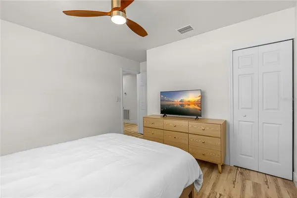 a bedroom with a bed and a flat screen tv