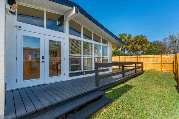 a view of a roof deck with couches and wooden floor