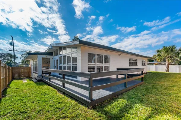 a view of a house with backyard and sitting area