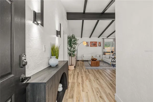 a view of living room with furniture and wooden floor
