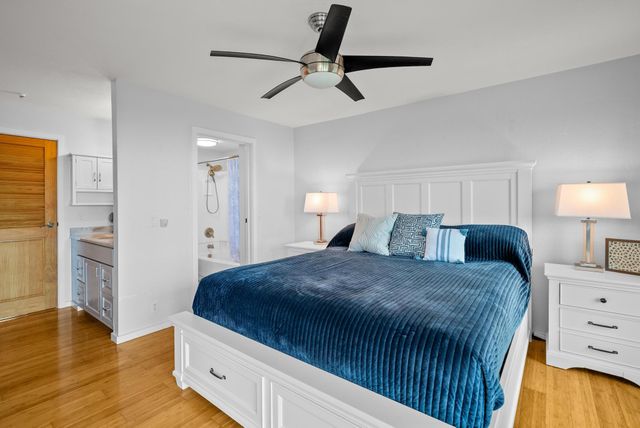 a bedroom with a bed and wooden floor