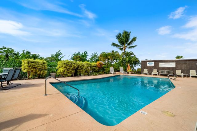 a view of a swimming pool with a yard