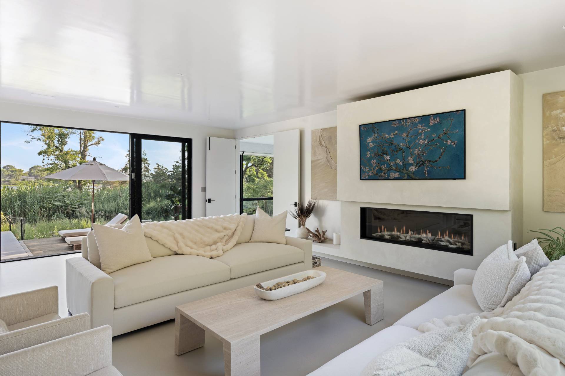 4 3rd Street Sag Harbor, NY 11963 - Photo 17 of 45 a living room with furniture a fireplace and a large window