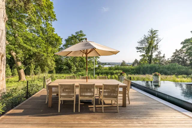 a living room with furniture a fireplace and a large window