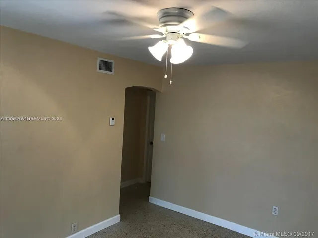 a view of a chandelier fan and a hallway