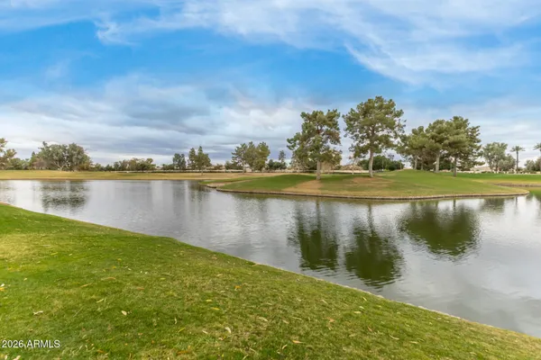 a view of a lake with houses in the back