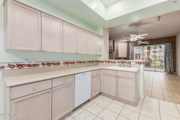 a kitchen with white cabinets and white appliances