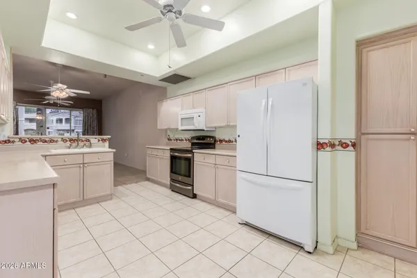 a kitchen with stainless steel appliances granite countertop a sink and cabinets