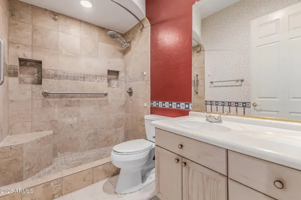 a bathroom with a shower sink and mirror