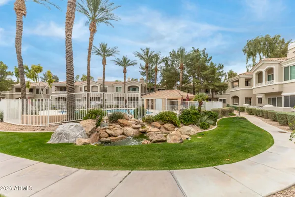 a view of a house with a backyard porch and sitting area