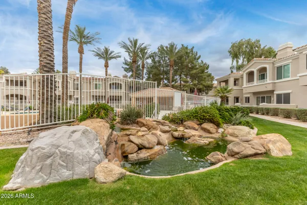 a view of a house with a yard and potted plants