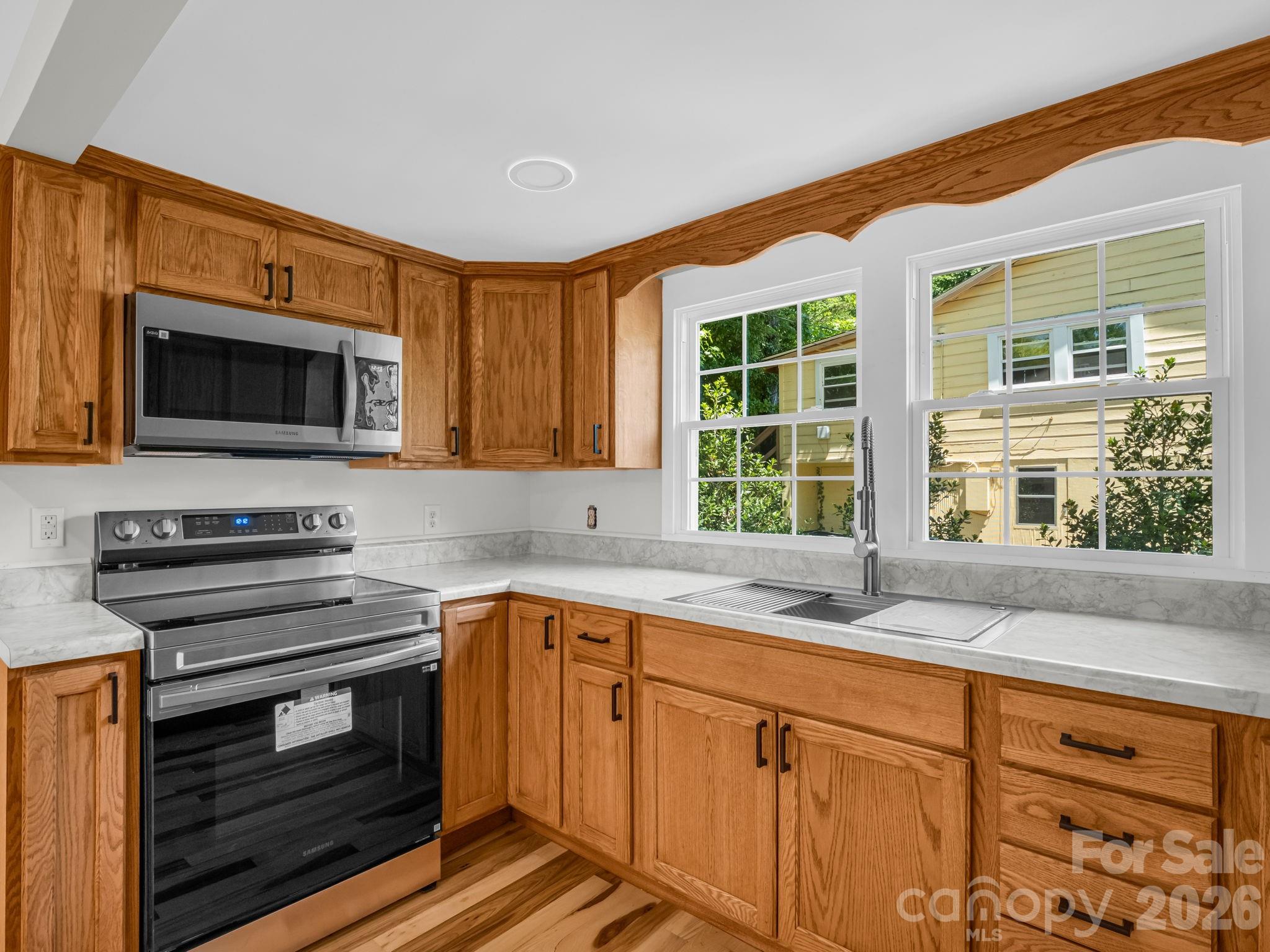 5923 Highway 14 Landrum, SC 29356 - Photo 5 of 15 a kitchen with stainless steel appliances a stove sink and microwave