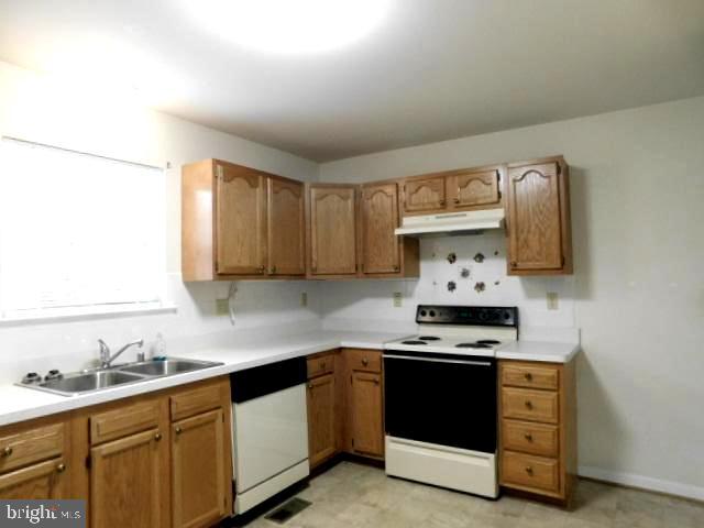 5013 Decatur Street St. Leonard, MD 20685 - Photo 14 of 45 a kitchen with stainless steel appliances a sink stove and cabinets