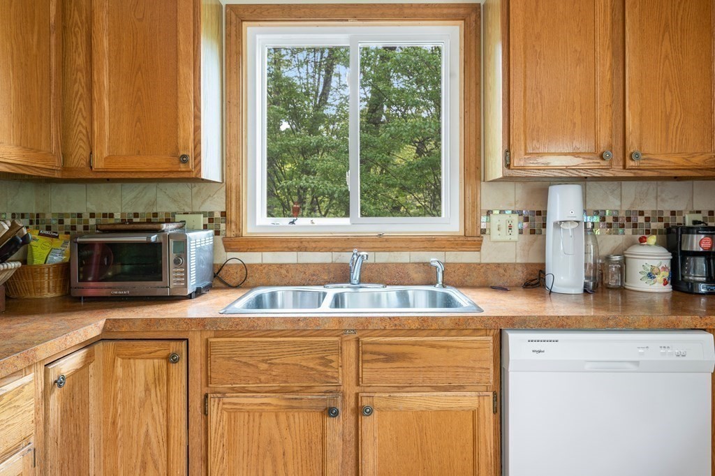 32 Middle Road Southampton, MA 01073 - Photo 15 of 39 a kitchen with granite countertop a sink stove and cabinets