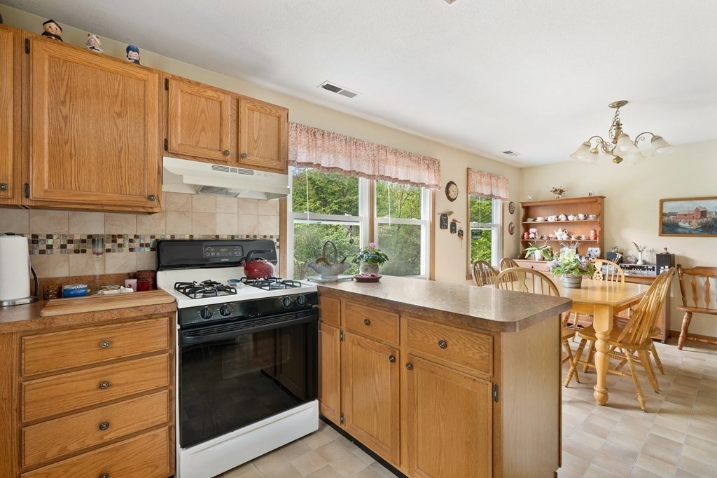 32 Middle Road Southampton, MA 01073 - Photo 17 of 39 a kitchen with a stove window and cabinets