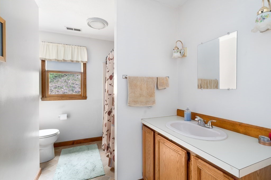 32 Middle Road Southampton, MA 01073 - Photo 32 of 39 a bathroom with a sink a toilet and mirror