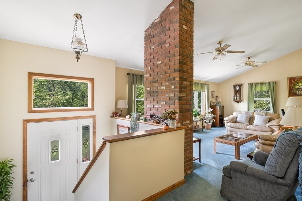 32 Middle Road Southampton, MA 01073 - Photo 10 of 39 a living room with furniture a window and chandelier