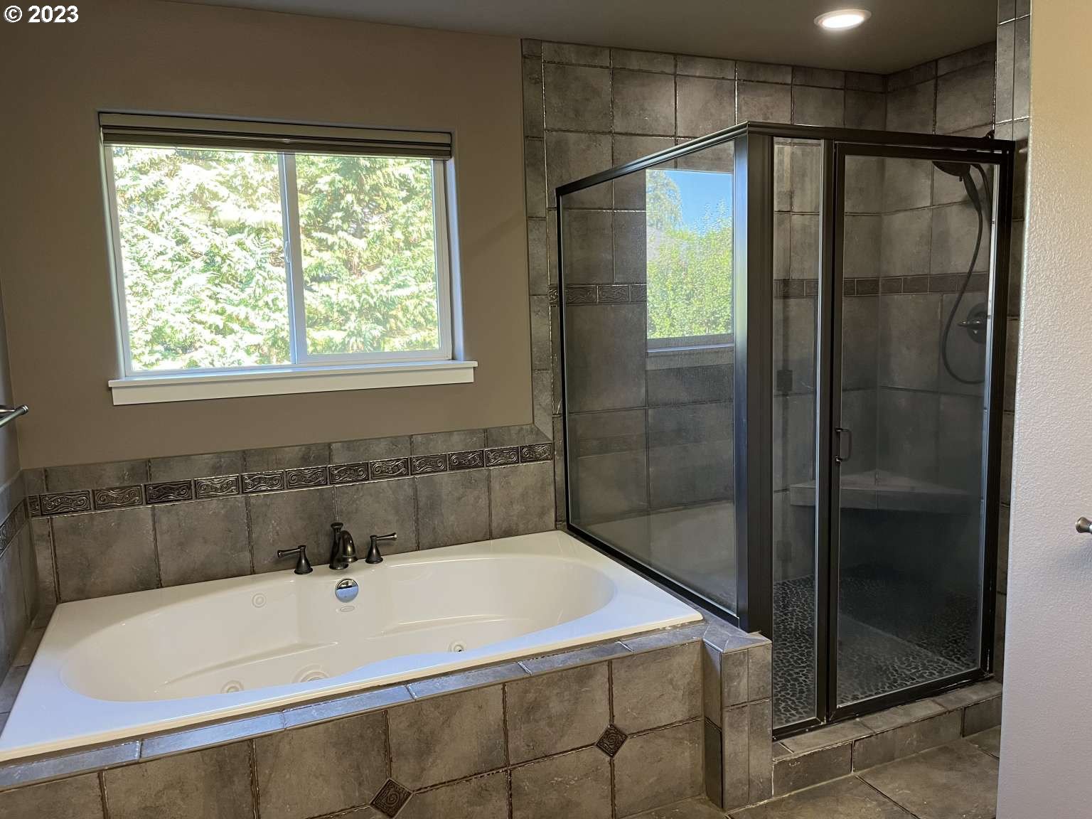 199 Northwest Camp Ireland Street Hillsboro, OR 97124 - Photo 16 of 36 a bathroom with a bathtub and a shower