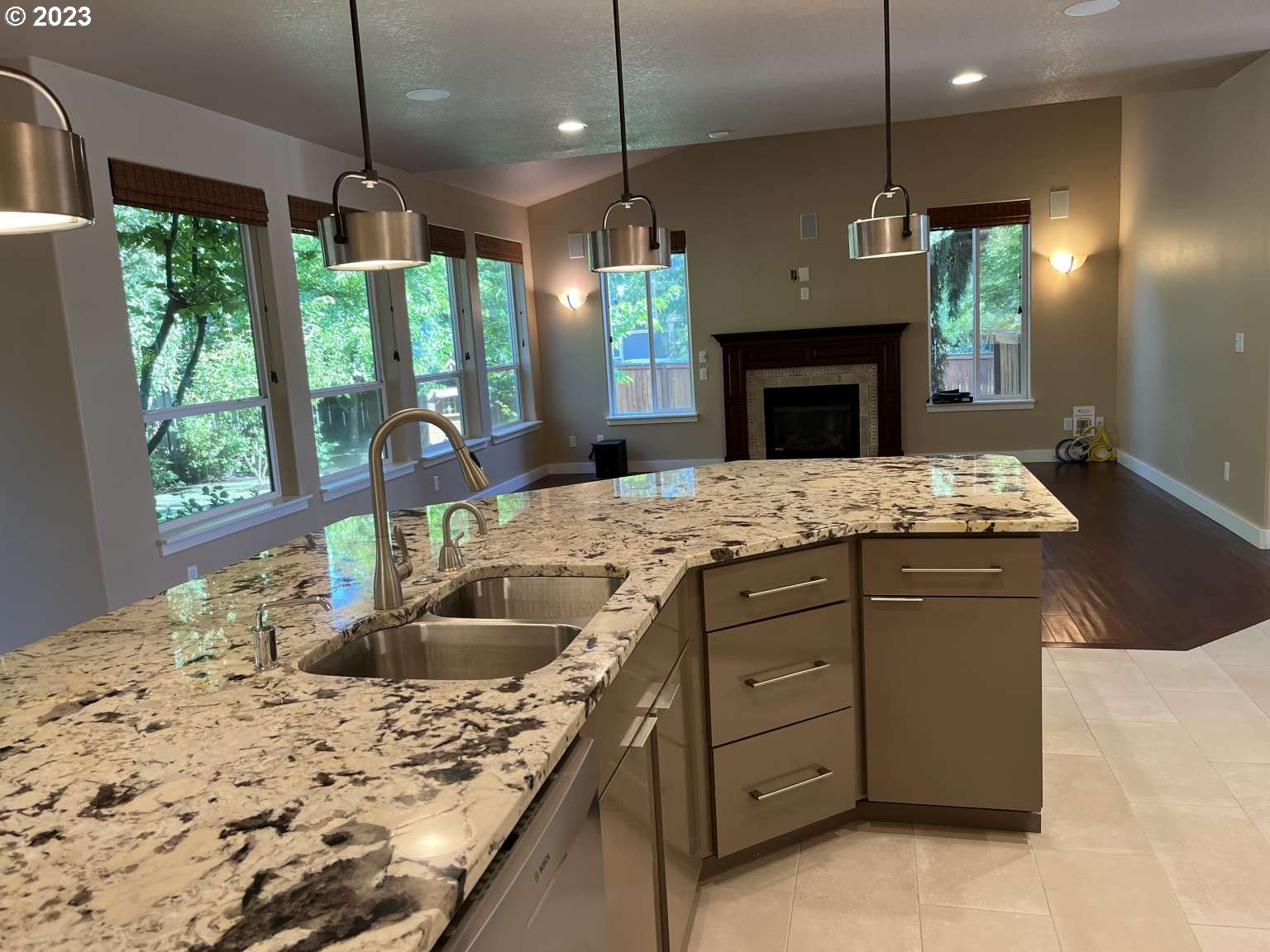 199 Northwest Camp Ireland Street Hillsboro, OR 97124 - Photo 2 of 36 a kitchen with kitchen island granite countertop a sink a counter top space appliances and cabinets