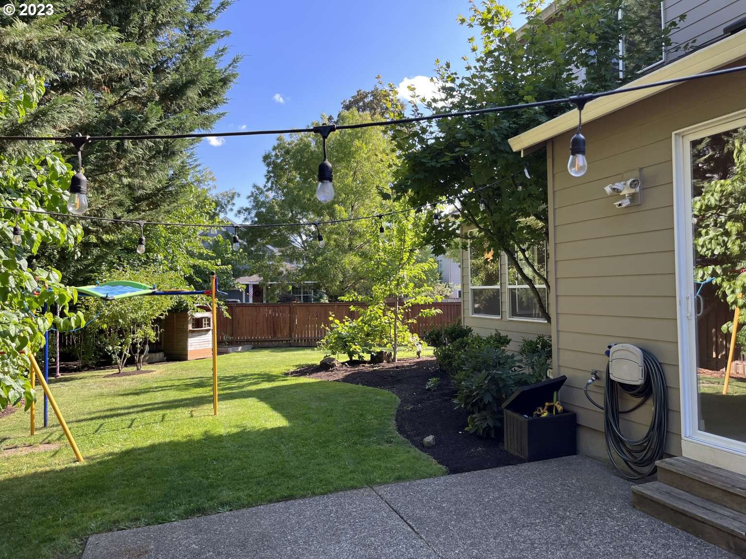 199 Northwest Camp Ireland Street Hillsboro, OR 97124 - Photo 26 of 36 a view of a backyard with plants and a patio