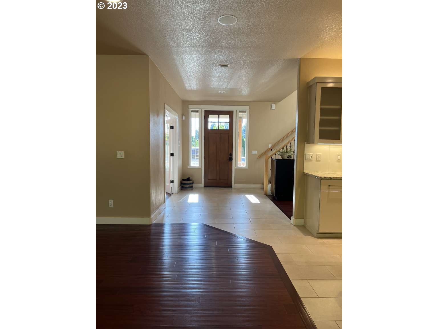 199 Northwest Camp Ireland Street Hillsboro, OR 97124 - Photo 31 of 36 a view of a hallway to an empty room with wooden floor and a kitchen view