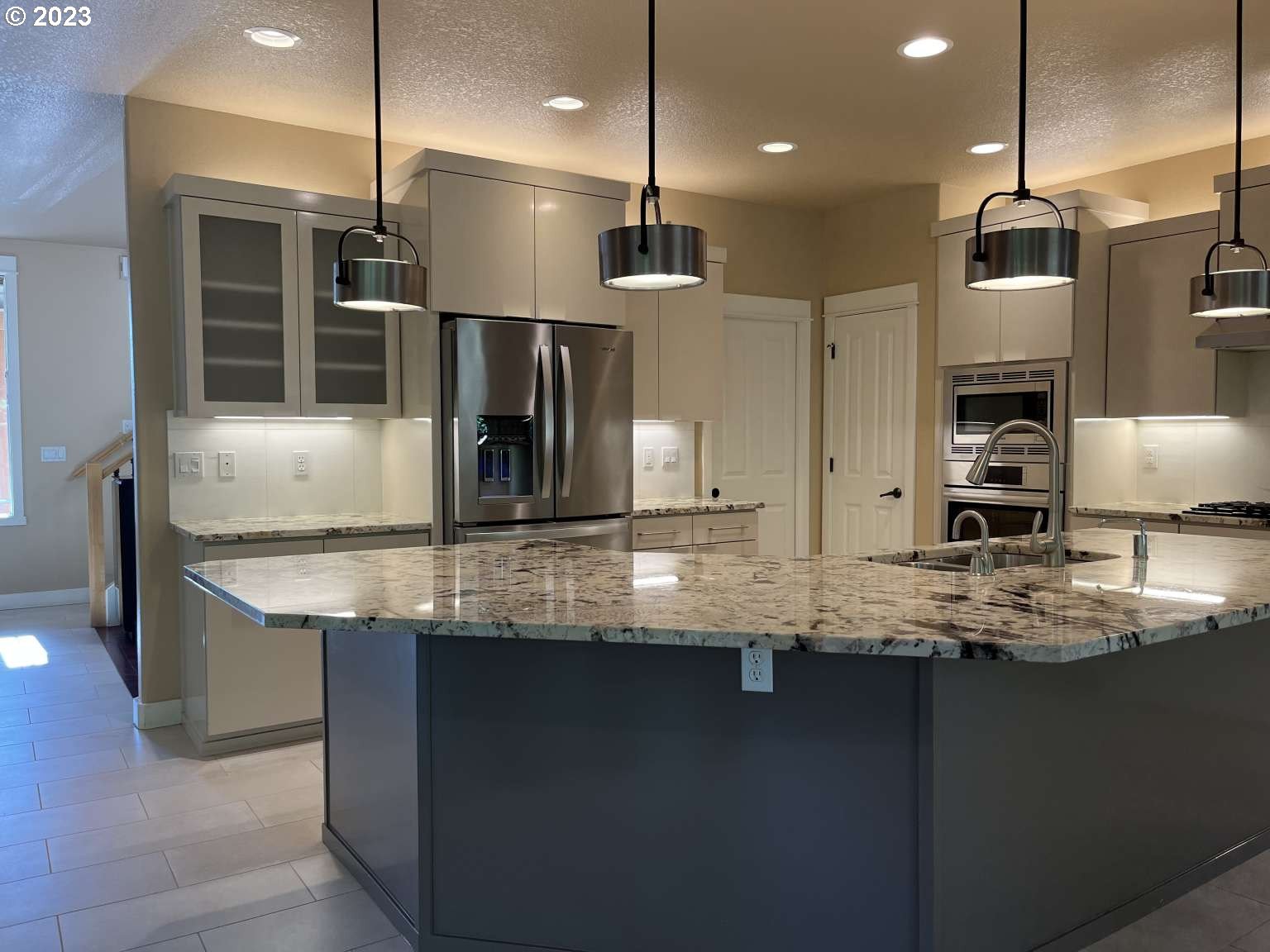 199 Northwest Camp Ireland Street Hillsboro, OR 97124 - Photo 35 of 36 a kitchen with kitchen island granite countertop a counter space stainless steel appliances and cabinets