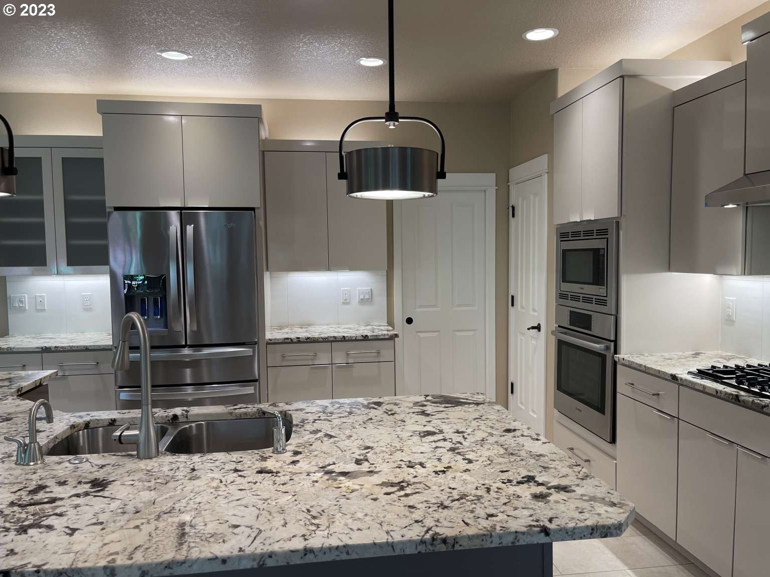 199 Northwest Camp Ireland Street Hillsboro, OR 97124 - Photo 36 of 36 a kitchen with stainless steel appliances granite countertop a sink refrigerator and cabinets